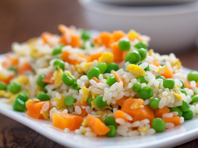 Restaurant style fried rice served in a bowl with vegetables and eggs