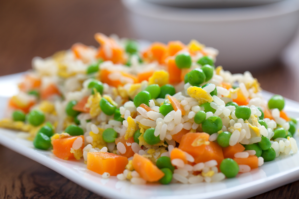 Restaurant style fried rice served in a bowl with vegetables and eggs