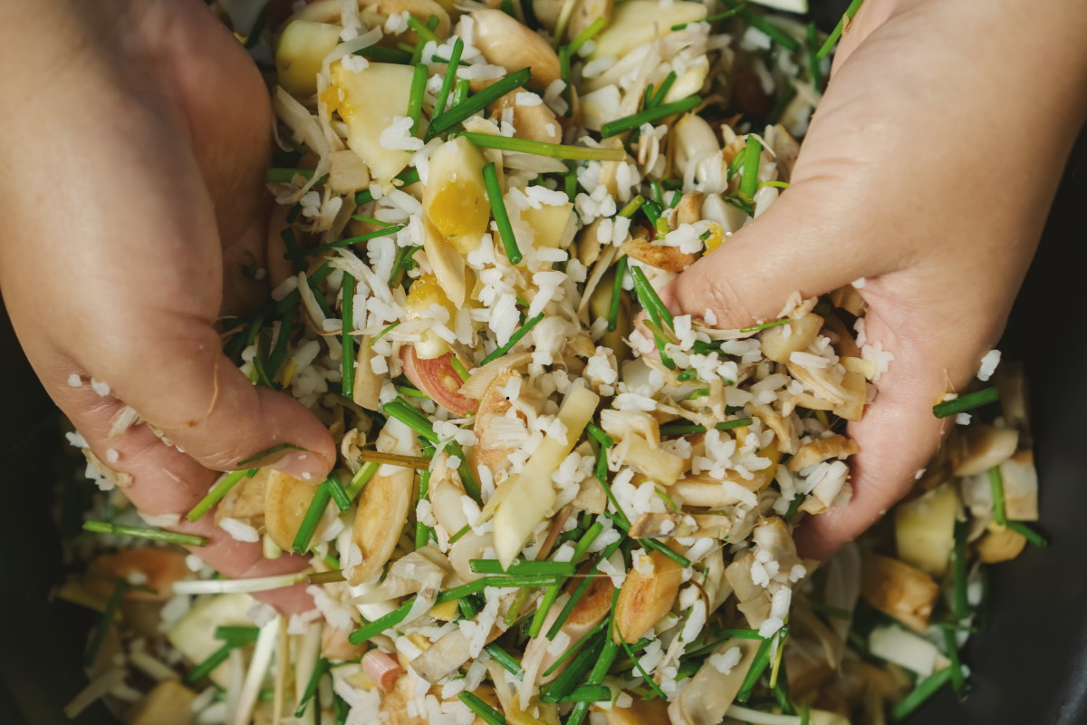Hands mixing vegetables and spices