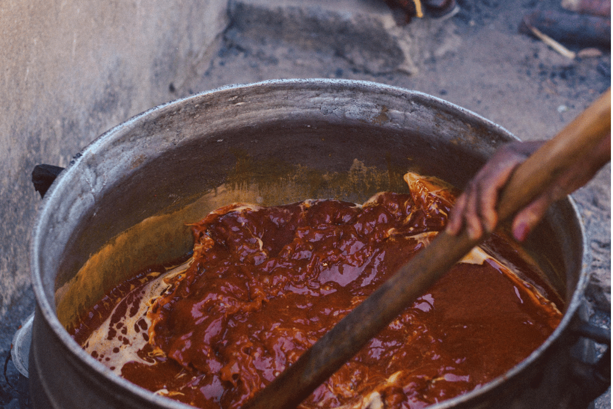 Cooking Smoky Party Jollof Rice Recipe in a large pot
