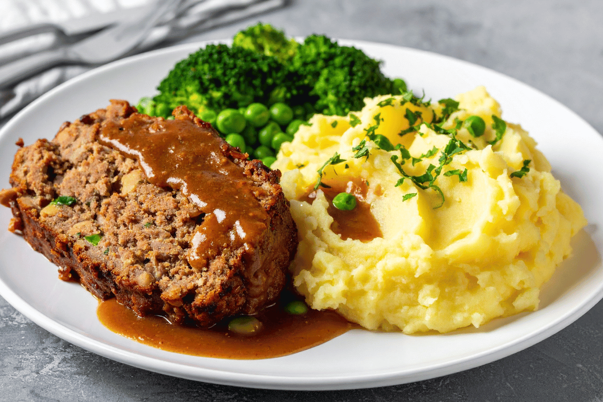 Easy homemade meatloaf recipe served with mashed potatoes