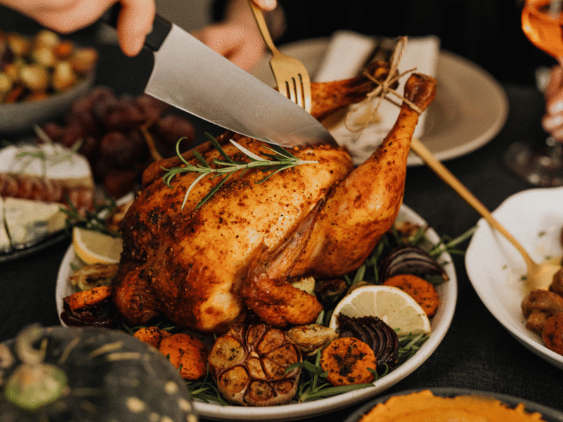 Make-ahead Thanksgiving recipes served on a festive holiday dinner table.