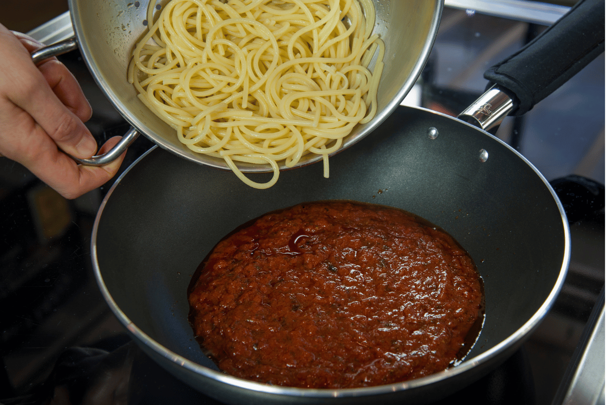 Adding pasta to sauce immediately after draining prevents sticking