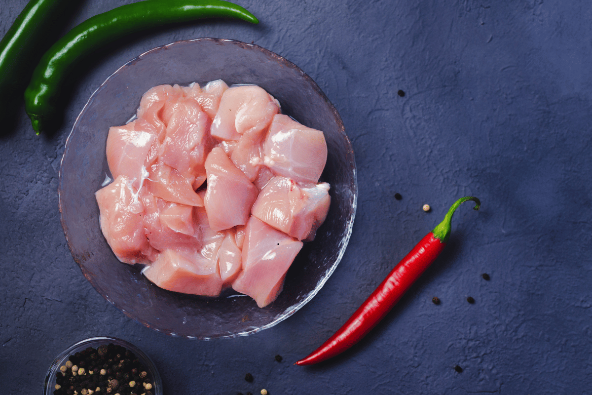 Cutting chicken into bite-sized pieces for Easy Garlic Butter Chicken Bites