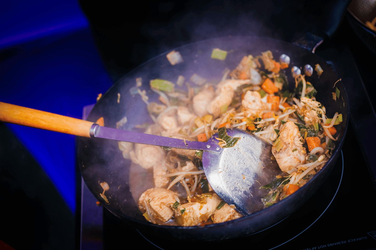 Chicken and vegetables cooking in a wok