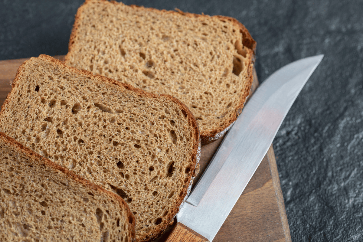 Fresh homemade bread sliced on a wooden board