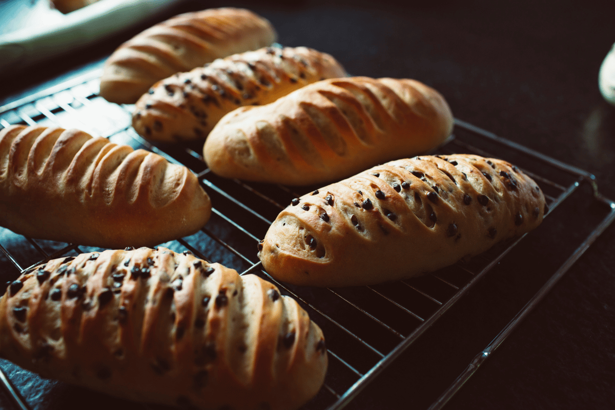 Golden brown homemade bread cooling on a wire rack