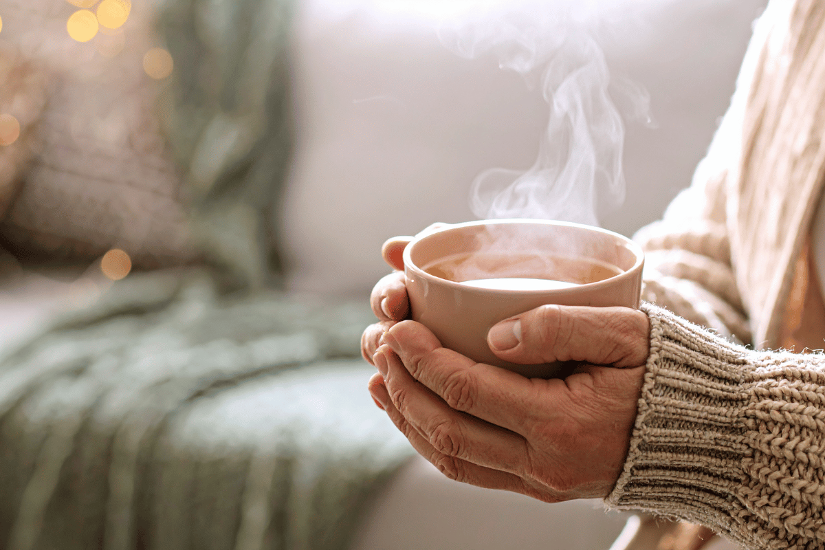 Person enjoying a warm bowl of homemade soup during fall