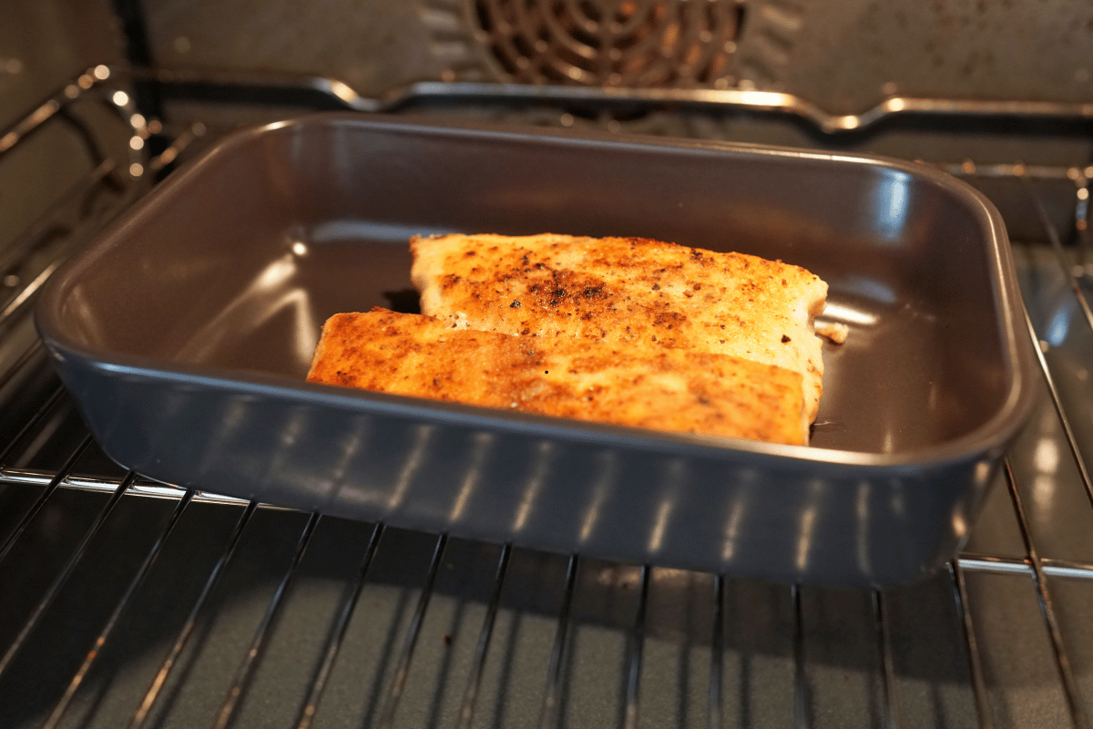 Baked salmon roasting with vegetables in the oven