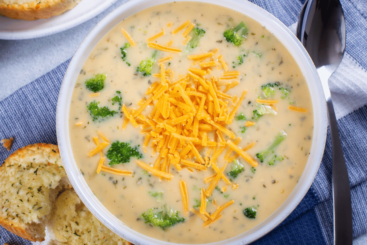 Creamy broccoli cheddar soup served in a bread bowl