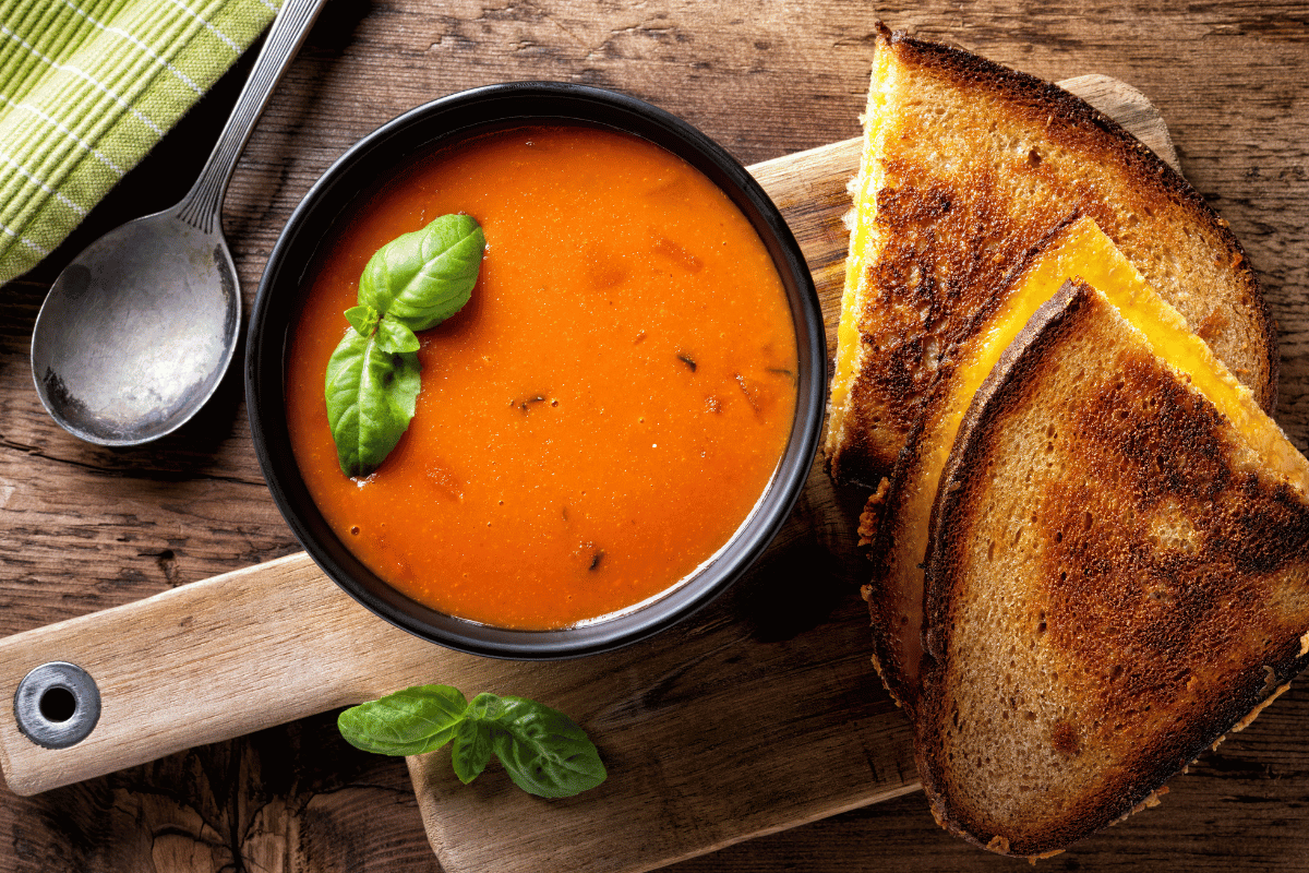 Creamy tomato basil soup served with grilled cheese