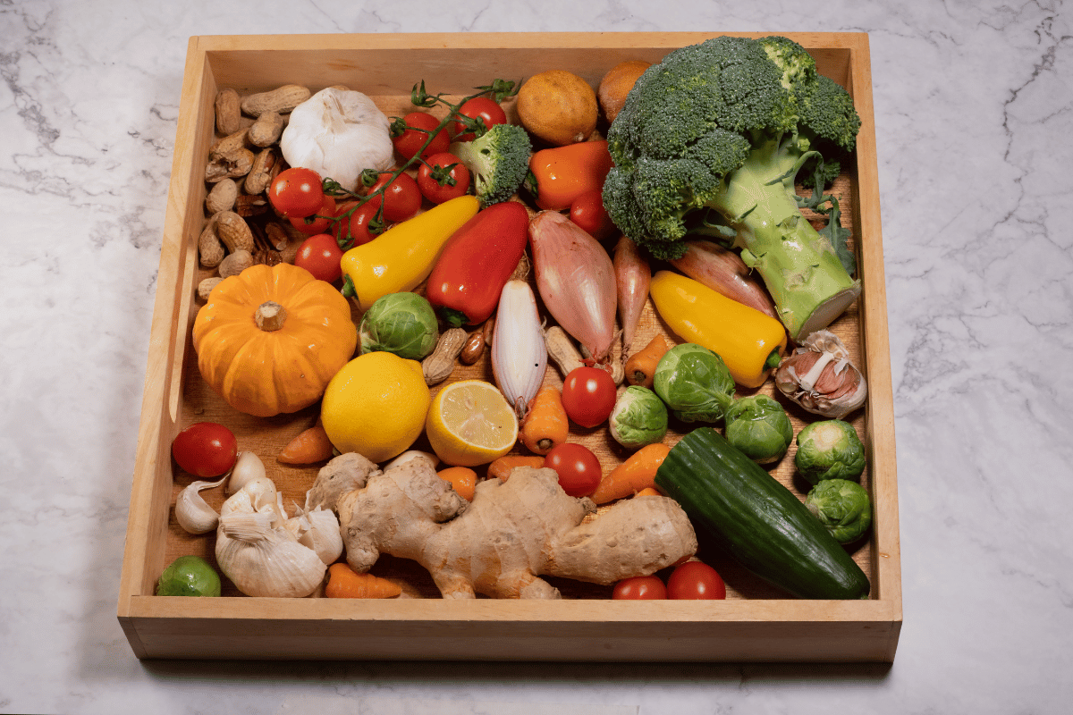 Roasted vegetables prepared for baking with salmon