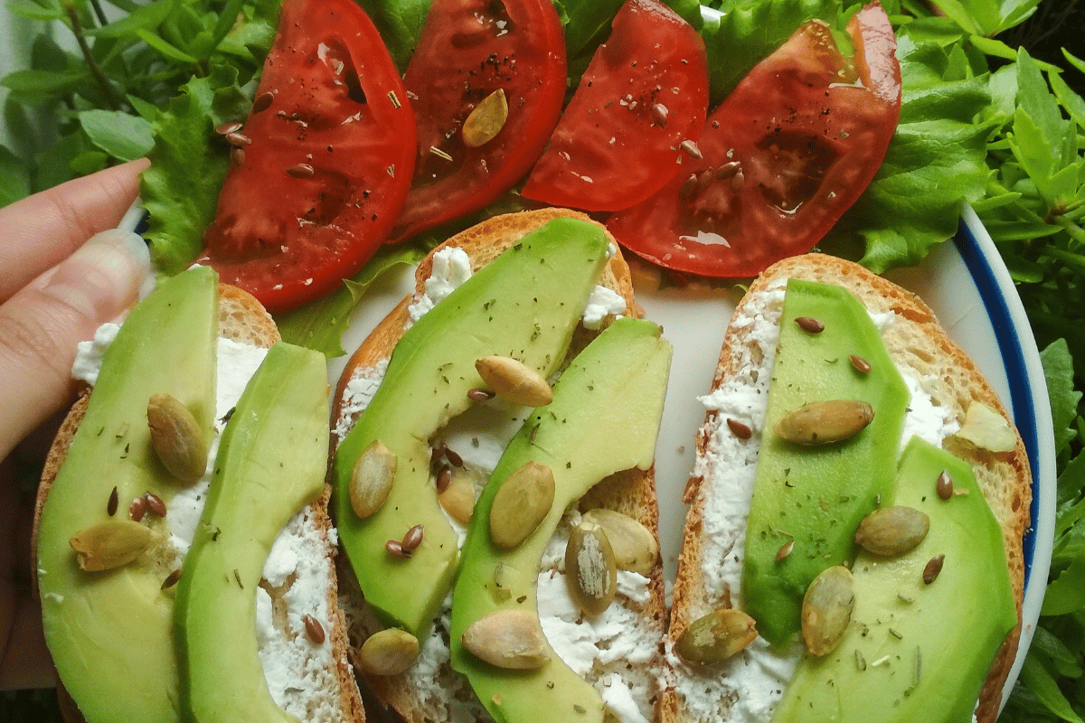 Whole-grain avocado toast with tomatoes and pumpkin seeds