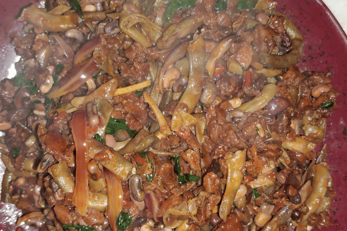 Fresh akidi and achicha recipe served with ukpaka, garden eggs, and palm oi