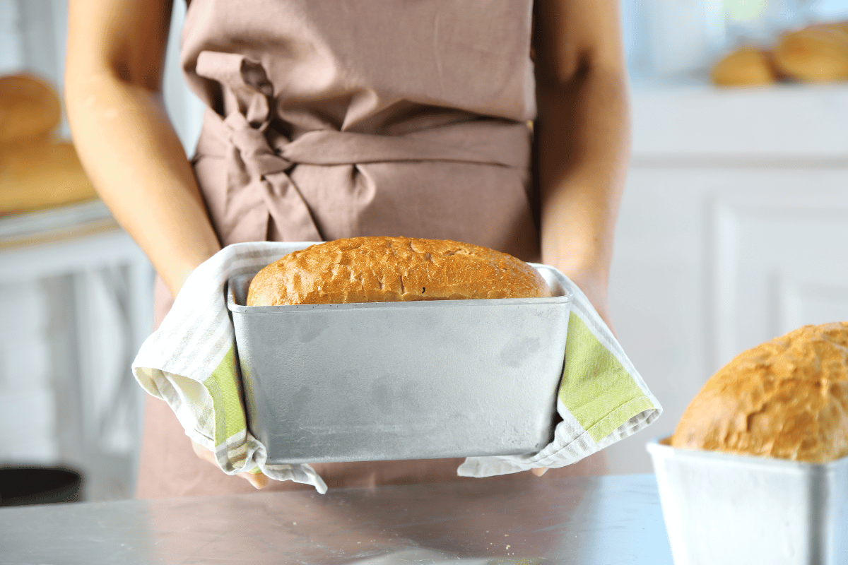 Home baker proudly holding a freshly baked homemade cake