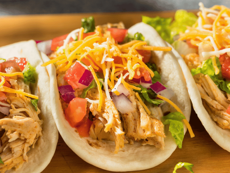 Crockpot Chicken tacos with shredded chicken and fresh toppings