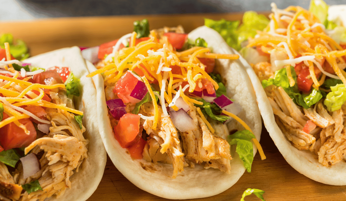 Crockpot Chicken tacos with shredded chicken and fresh toppings