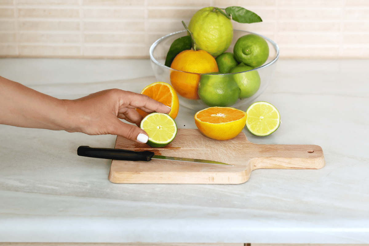 Rolling fresh lemons before making homemade lemonade