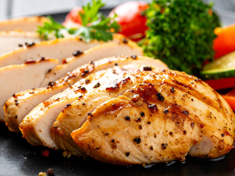 Sliced juicy chicken breast with vegetables
