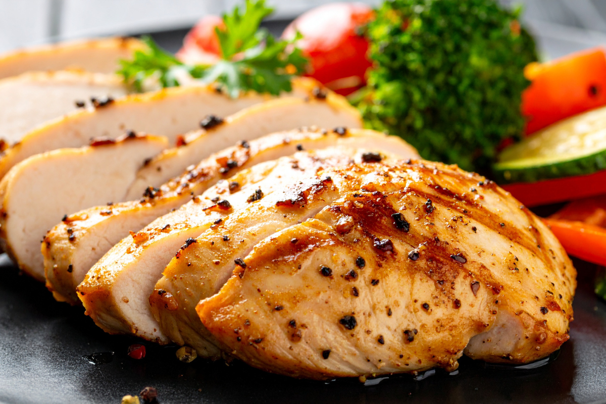 Sliced juicy chicken breast with vegetables