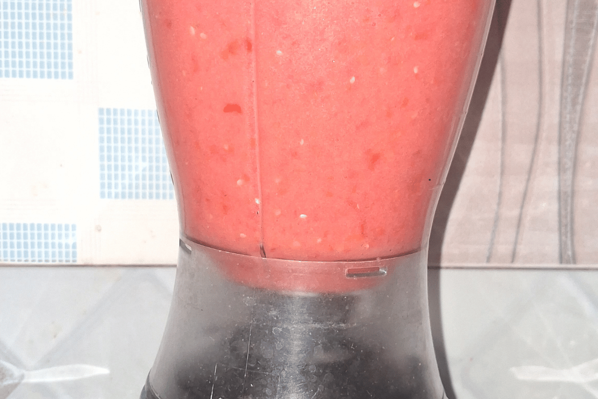Blending fresh tomatoes, onions, ginger, garlic, and pepper for a budget-friendly Nigerian fresh tomato stew recipe.
