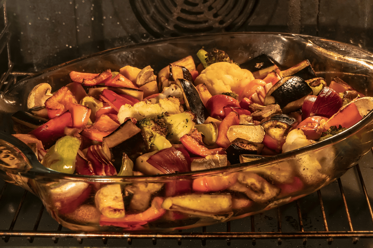 roasted  carrots cauliflower bell peppers res onion and mushrooms on baking sheet
