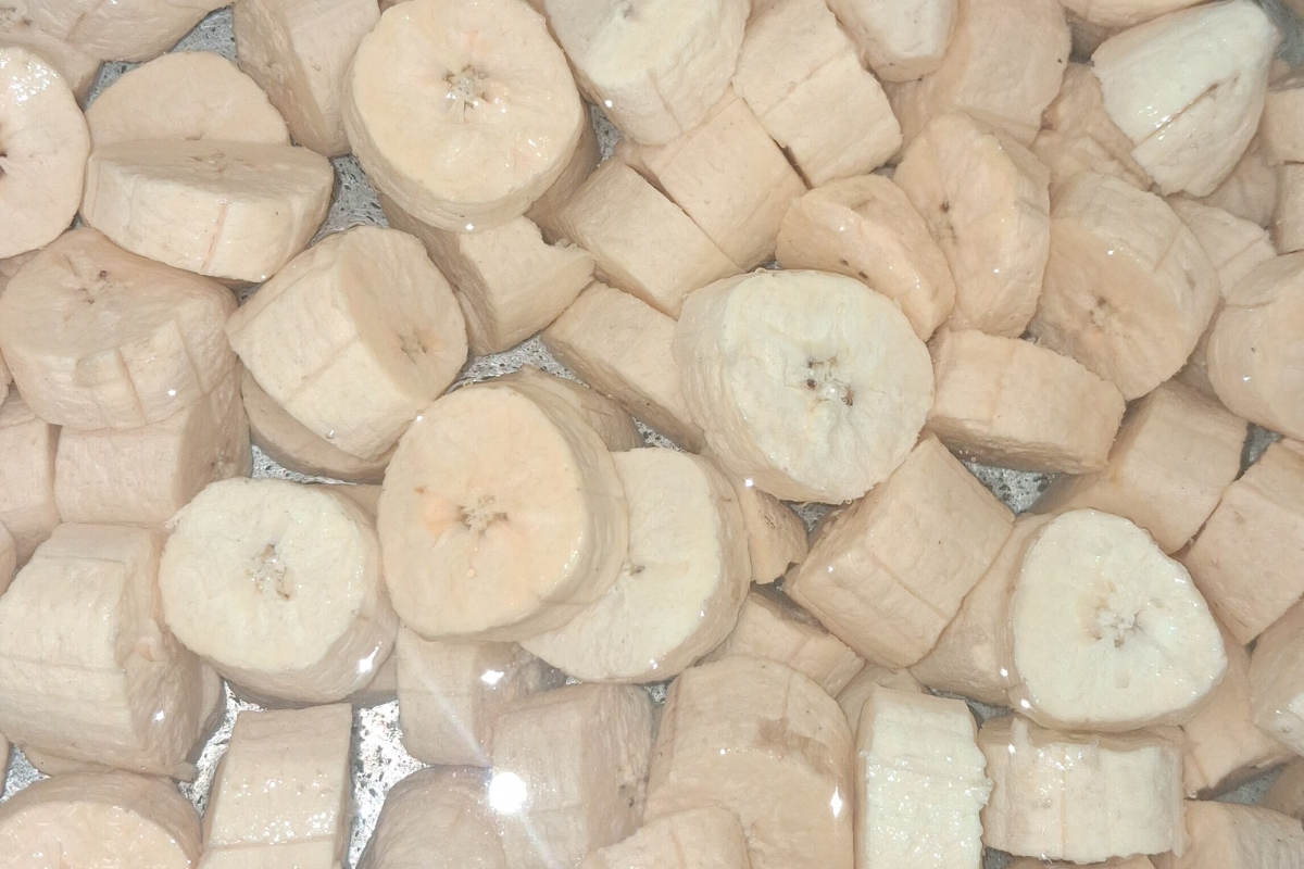 sliced unripe plantain in a pot of water