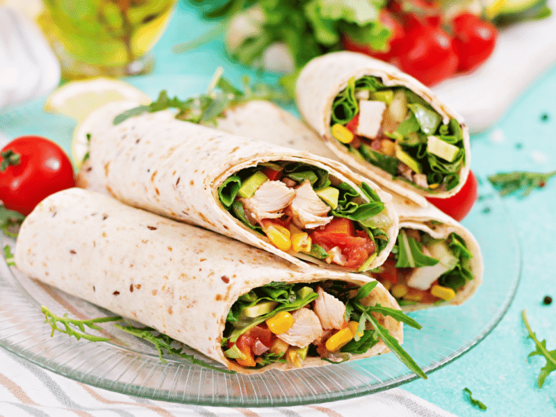 Whole grain turkey avocado wrap with sliced turkey.