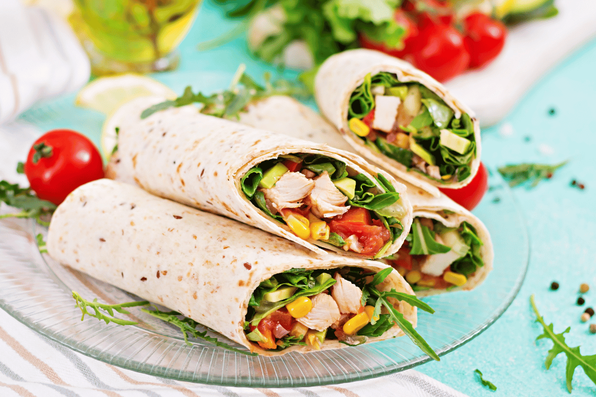 Whole grain turkey avocado wrap with sliced turkey.