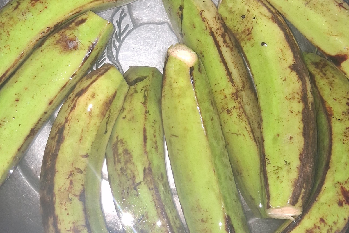unripe plantains soaking in water before peeling